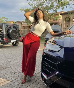 Londie London posing next to a Lamborghini Urus