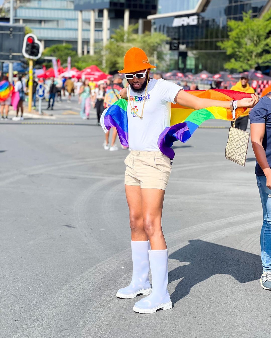 Mohale with a rainbow flag during Pride Day